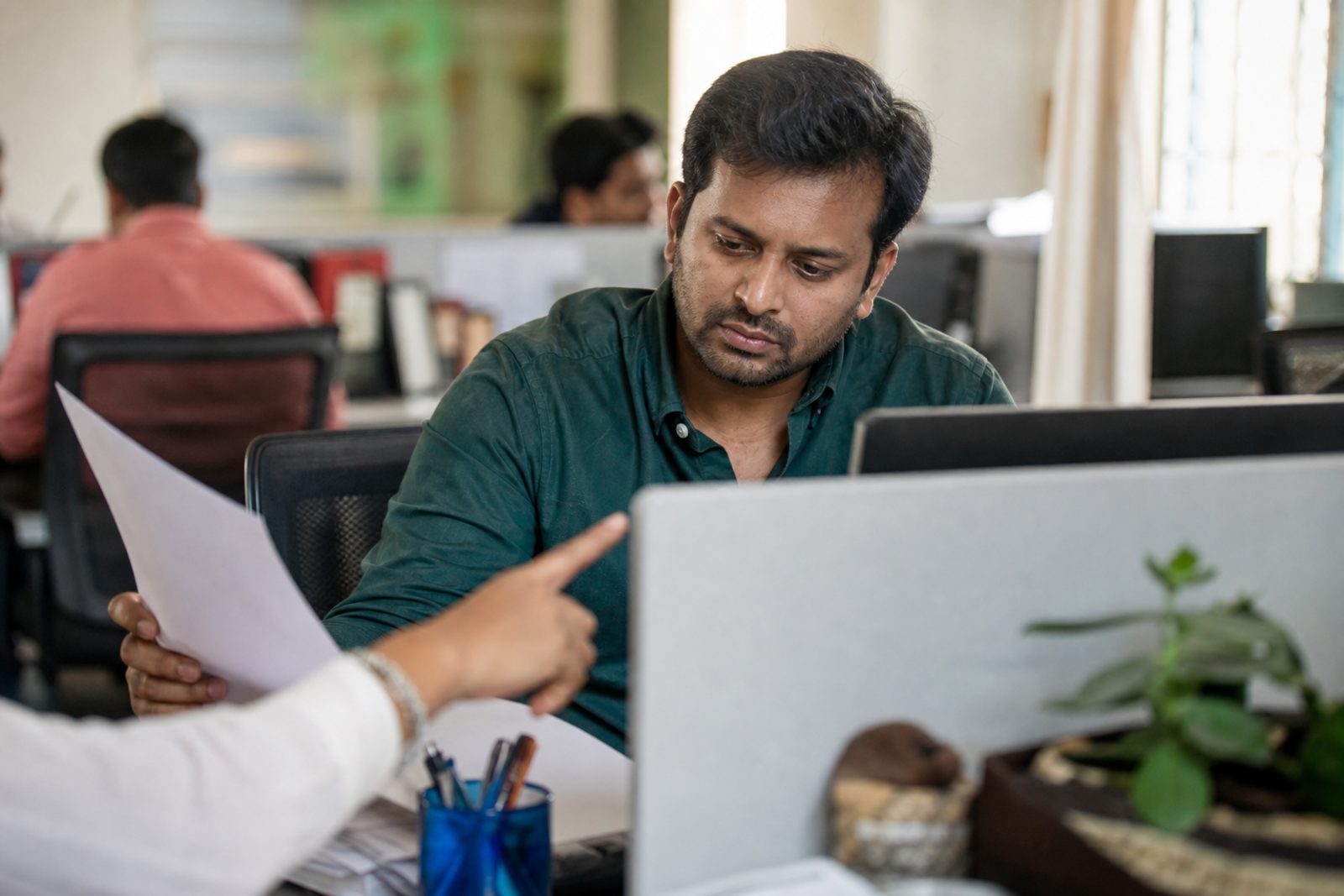 A support lead reviews a drafted customer complaint response with a checklist before approving it.